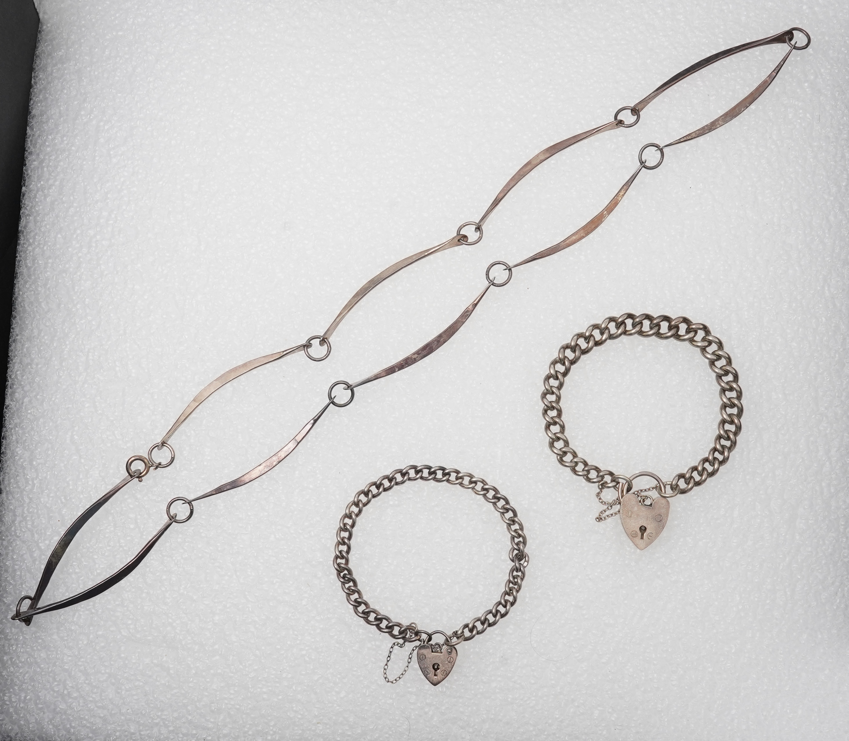 A 1960'sGeorg Jensen silver tie clip, design no. 63, 53mm, together with a stylish sterling necklace and two silver curb link bracelets.